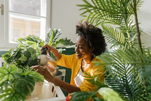 a woman watering plants